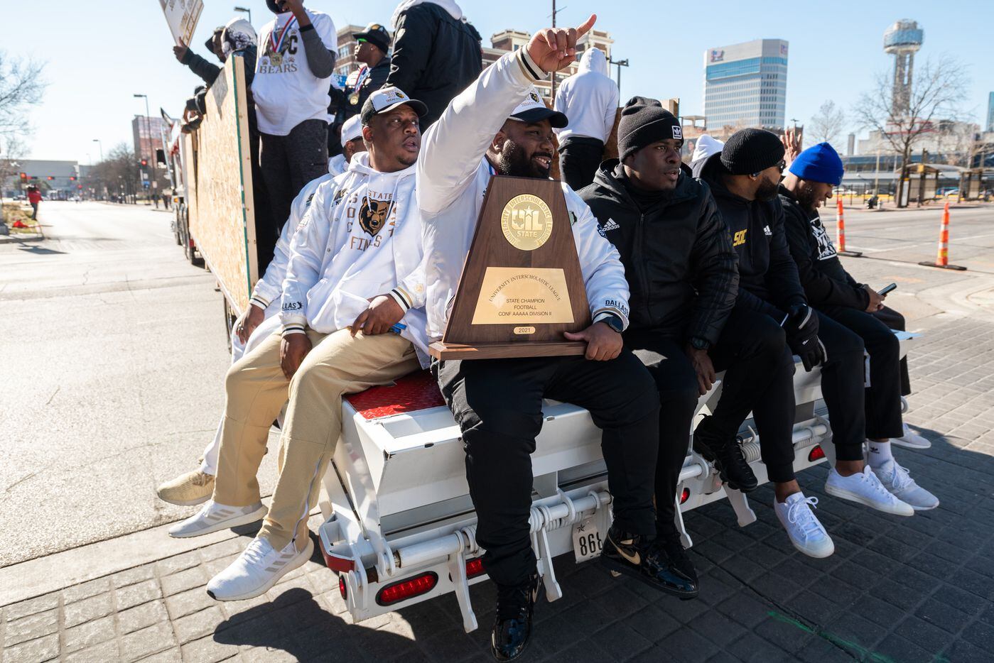 Football coach Ellis Wheatfall sits with the UIL 5A State Football Championship, next to...