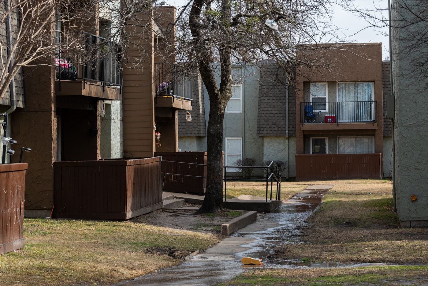 Sewer water floods the sidewalks outside of units at the Hillcrest apartments in Mesquite,...