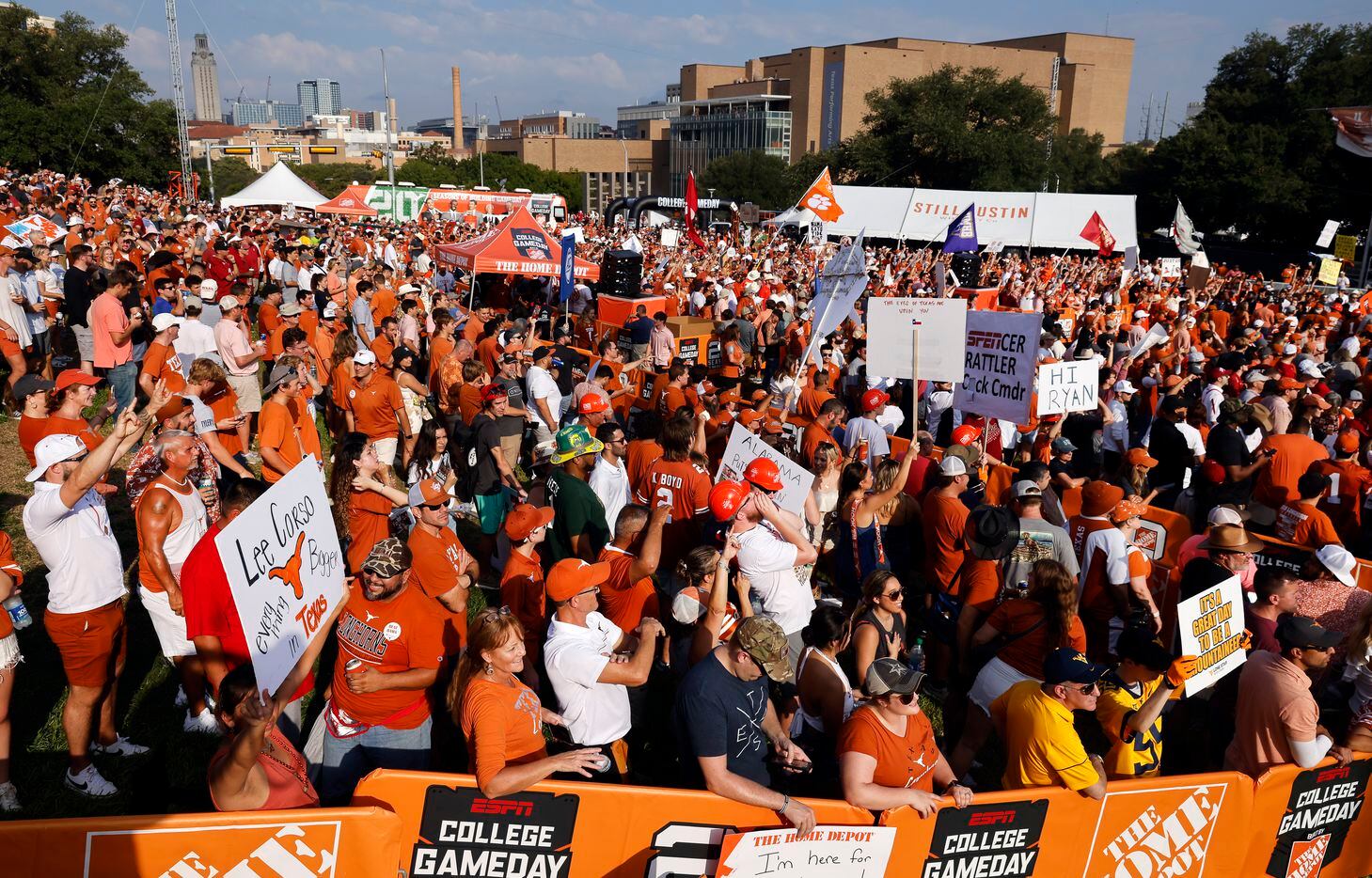 Texas Longhorns and Alabama Crimson Tide fans cheer behind ESPN’s College GameDay outside...