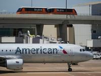 American Airlines planes are seen at the gates of Terminal C at DFW Airport on Saturday,...
