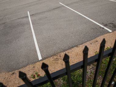 A locked fence and empty parking lot is seen Feb. 6, 2019, in the 2200 block of Burbank...