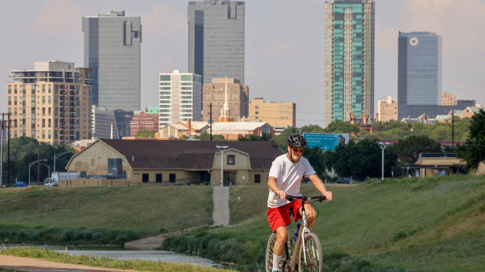 A cyclist rides along the trail at Trinity Park near downtown Fort Worth.