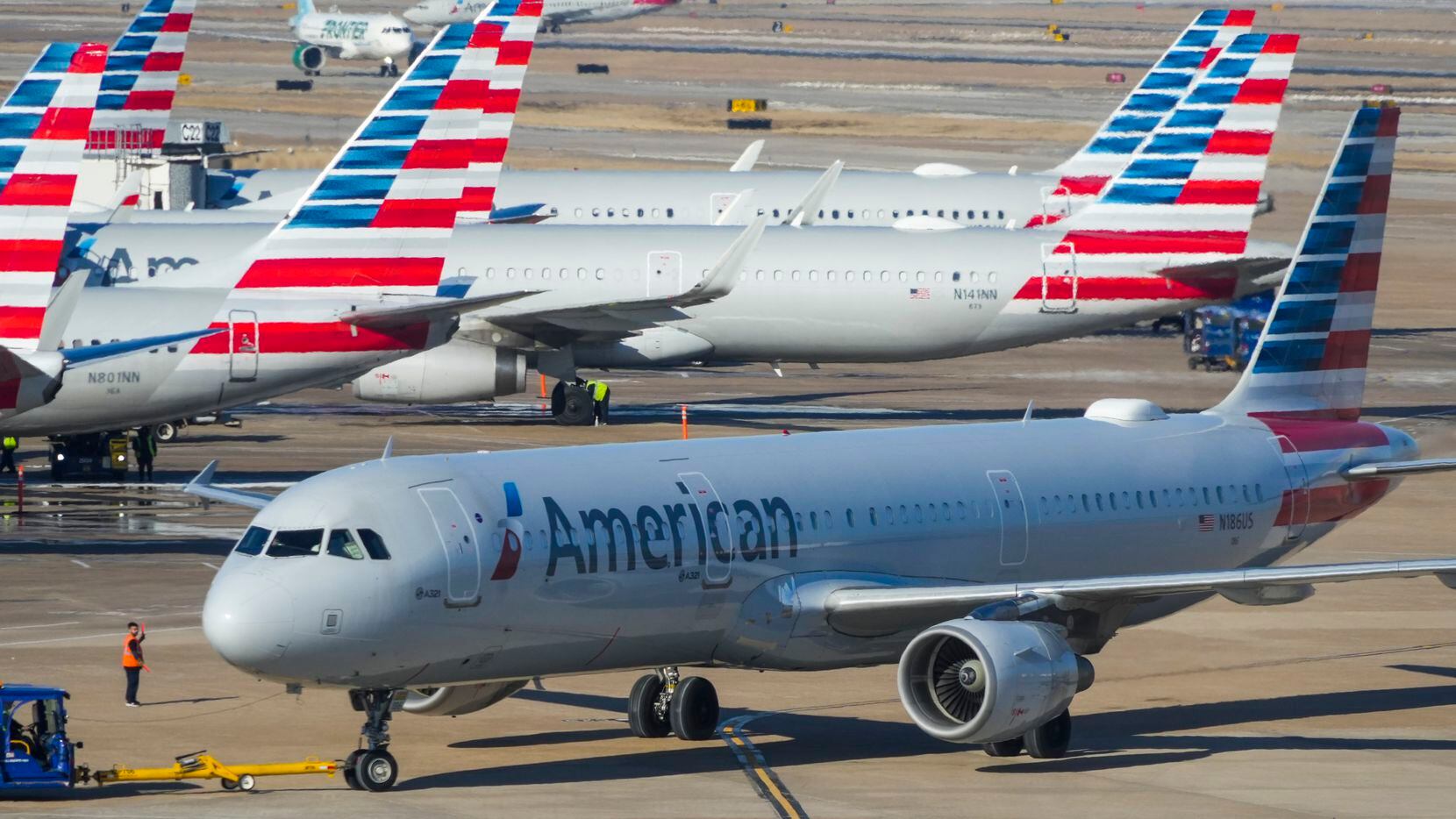 American Airlines planes are seen at the gates of Terminal C at DFW Airport on Friday, Feb....