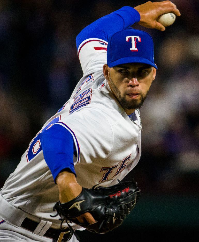Texas Rangers relief pitcher Alex Claudio (58) pitches during the seventh inning of an MLB...
