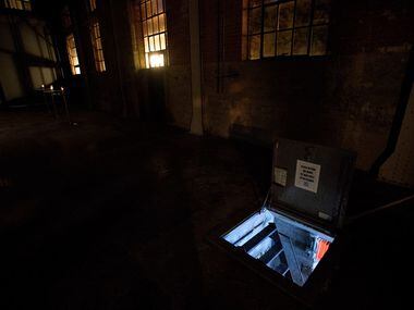 Light emanates from Culture Hole, a 44-square-foot underground art exhibition space with a...