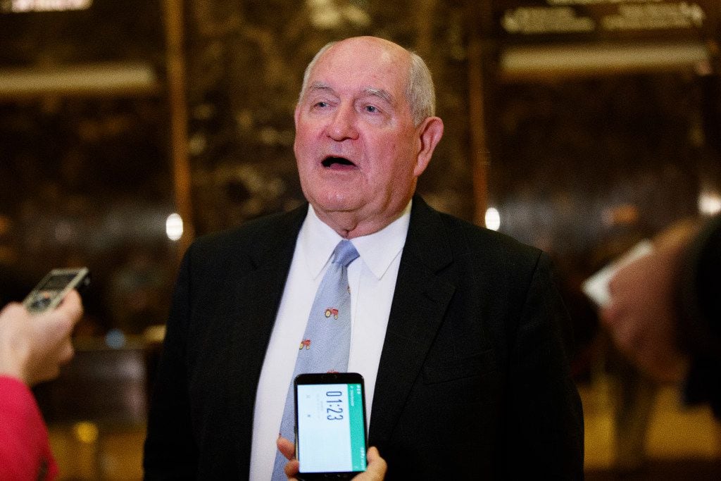 Former Georgia Gov. Sonny Perdue talks with reporters on Nov. 30 after meeting with...