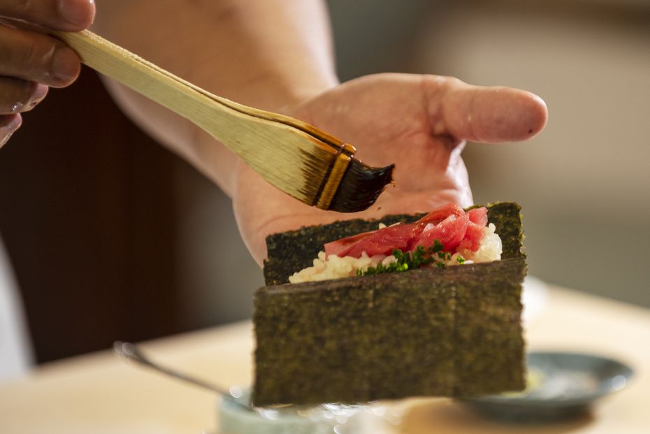 Chef Tatsuya Sekiguchi prepares a toro hand roll at a private tasting before his restaurant...