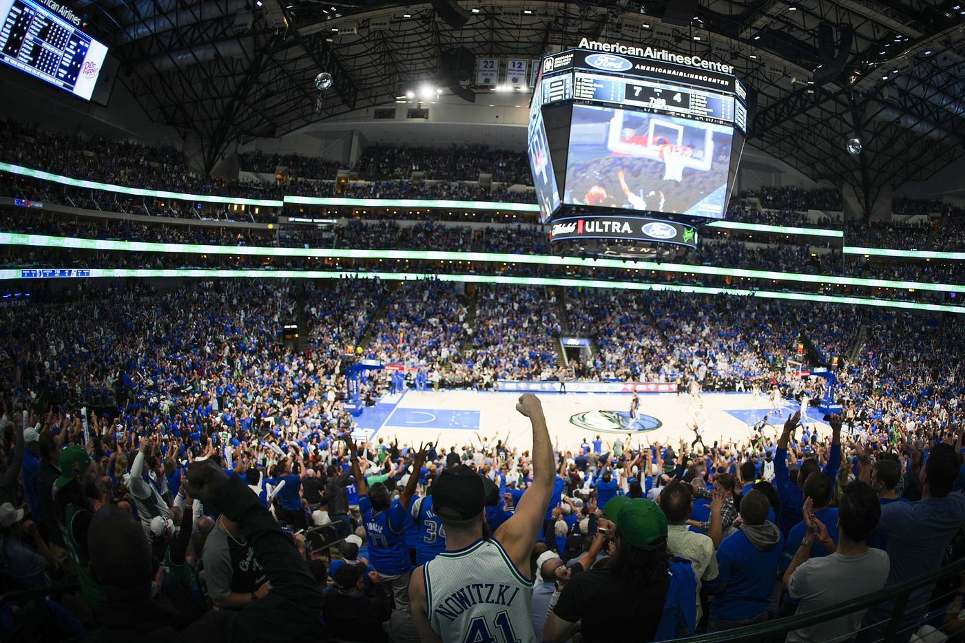 Dallas Mavericks fans cheer a basket during the first half in Game 5 of a NBA first round...