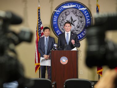 Dallas County Judge Clay Jenkins (right) and Dr. Philip Huang, Director of Dallas County Health and Human Services, ordered bars and restaurants to shut down throughout the area to help stem the new coronavirus at a press conference on March 16, 2020 in Dallas.