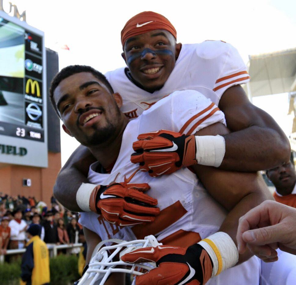 Texas' Chris Warren, front, and Ryan Newsome celebrate a 23-17 win over Baylor at McLane...