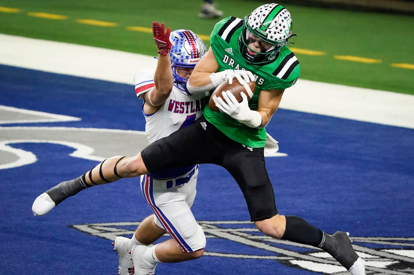 Southlake Carroll wide receiver Brady Boyd (14) catches a 27-yard touchdown pass as Austin Westlake defensive back Jax Crockett (4) defends during the second quarter of the Class 6A Division I state football championship game at AT&T Stadium on Saturday, Jan. 16, 2021, in Arlington, Texas. (Smiley N. Pool/The Dallas Morning News)