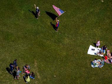 People gather at Winfrey Point at White Rock Lake after the The U.S. Navy Blue Angels fly...