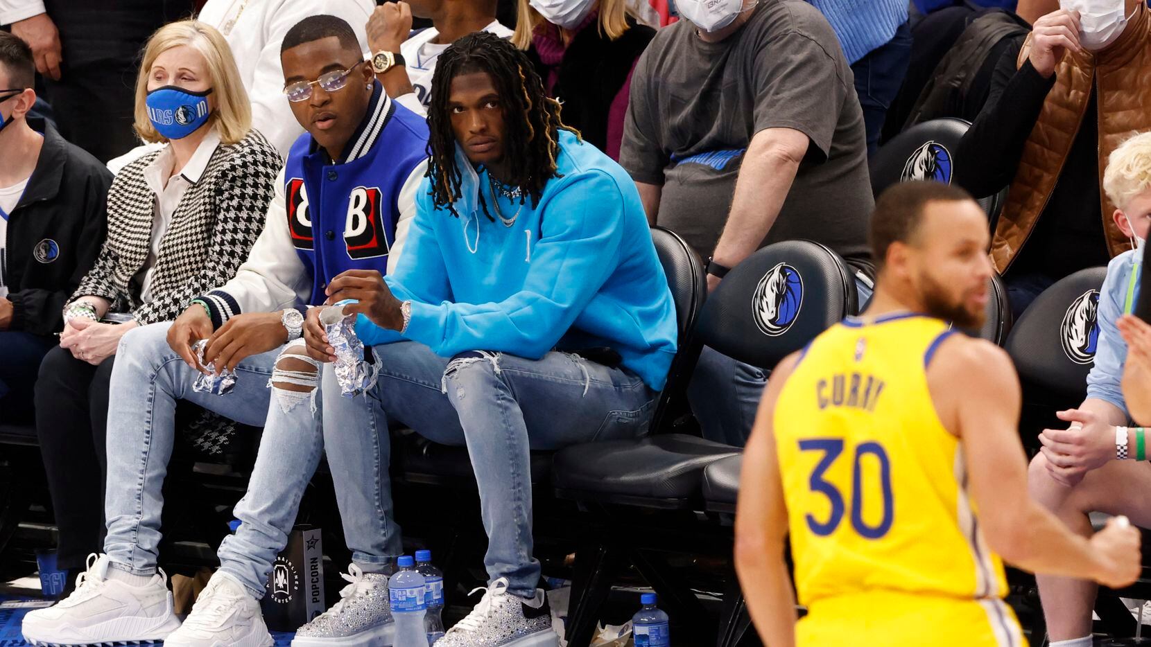 Dallas Cowboys wide receivers Amari Cooper and CeeDee Lamb, along with LA Dodgers Clayton Kershaw watch a game between the Dallas Mavericks and Golden State Warriors at American Airlines Center on Wednesday, January 5, 2022, in Dallas.
