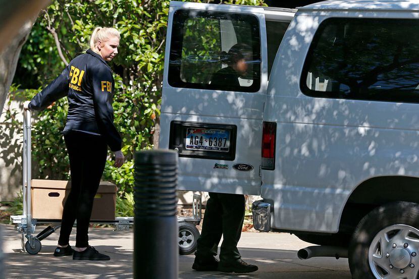 FBI agents loaded boxes into a van while as part of a raid on Medoc Health Services offices...