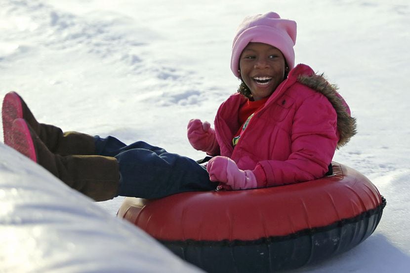Taryn McKinstry slides down a snow hill.
