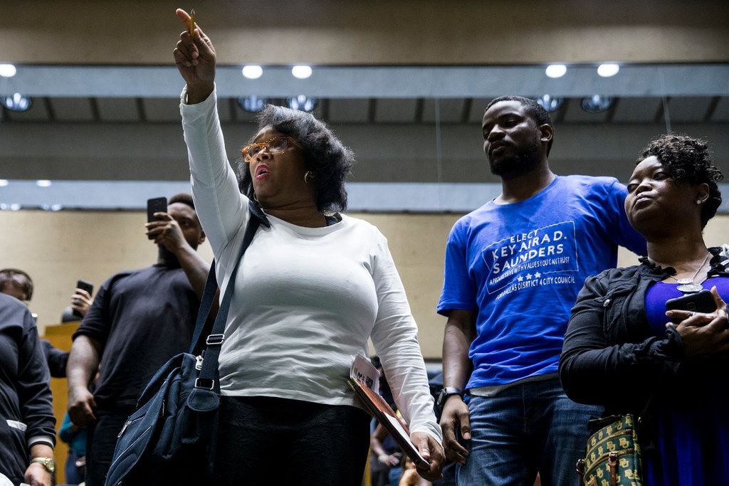 Olinka Green yells "No justice, no peace" after Mayor Mike Rawlings left the council...
