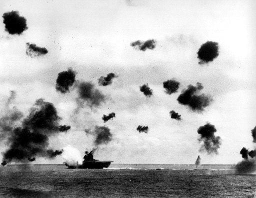Smoke rises from the USS Yorktown after a Japanese bomber hit the aircraft carrier in the...