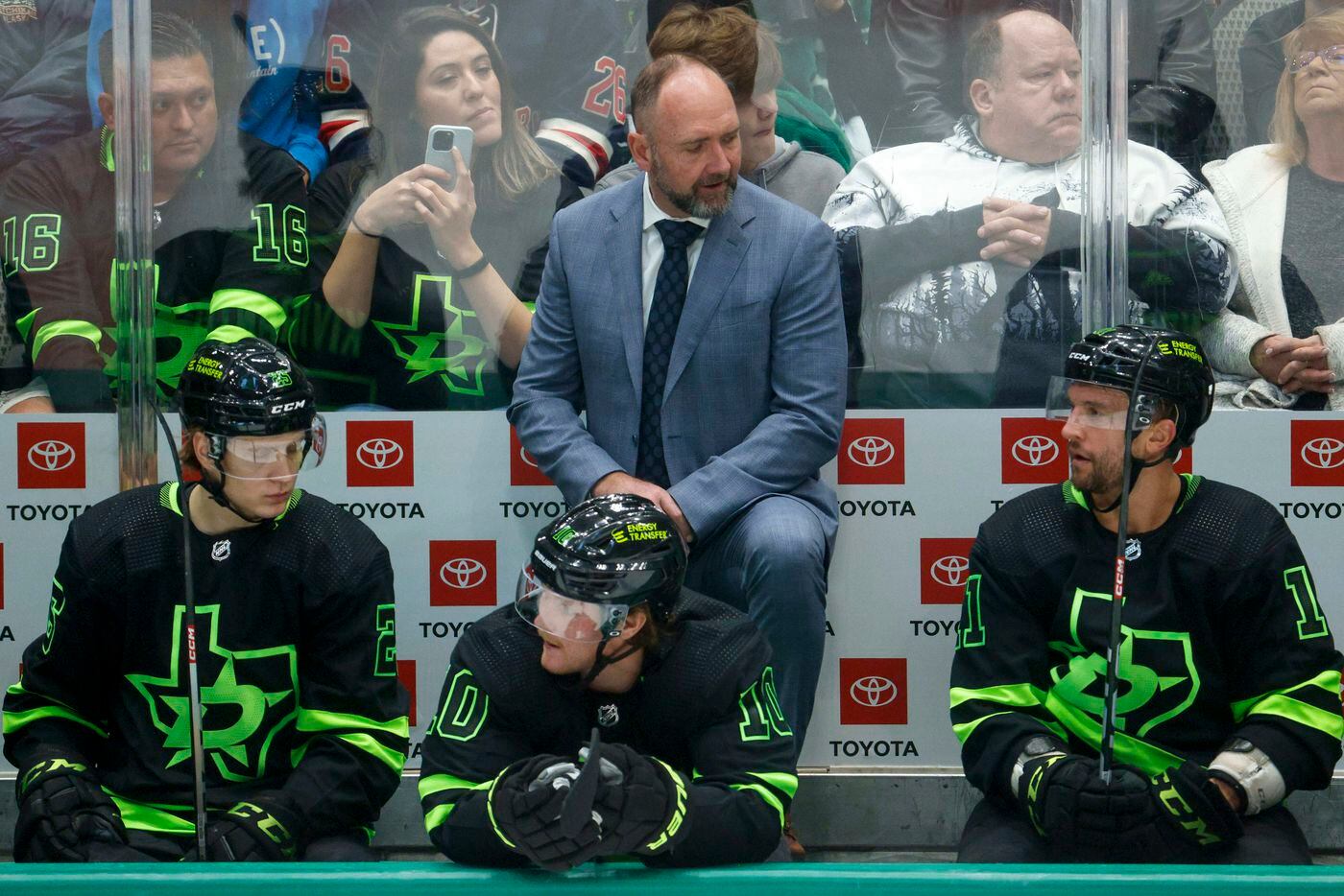 Dallas Stars head coach Peter DeBoer talks to his team on the bench during the second period...