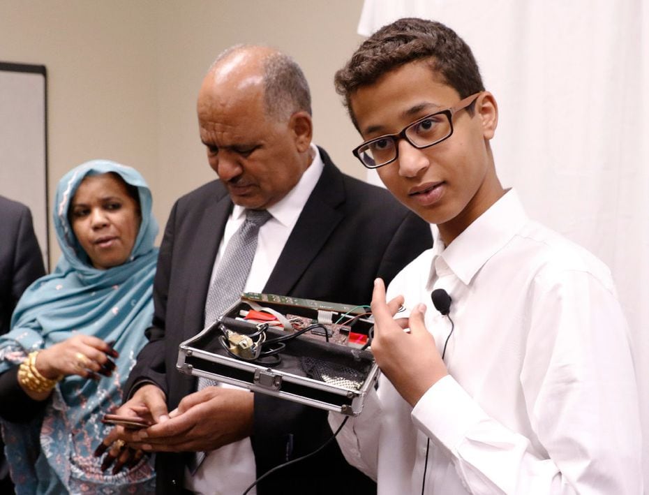 Ahmed Mohamed shows the clock he built in a school pencil box while standing with his...