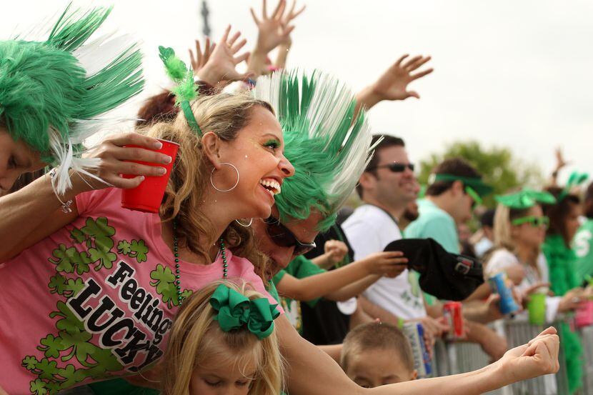 Kolleen Kiburz of Dallas tries to catch beads during St. Patrick's Day Parade on Greenville...
