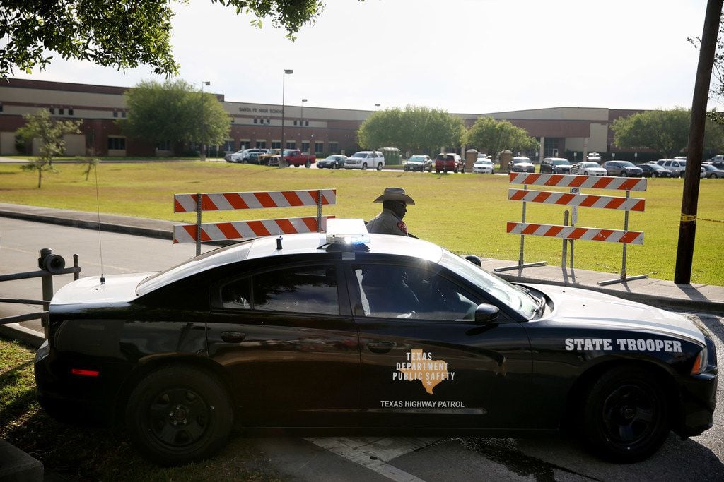 A Texas State Trooper stands outside of Santa Fe High School in Santa Fe, Texas Saturday May...