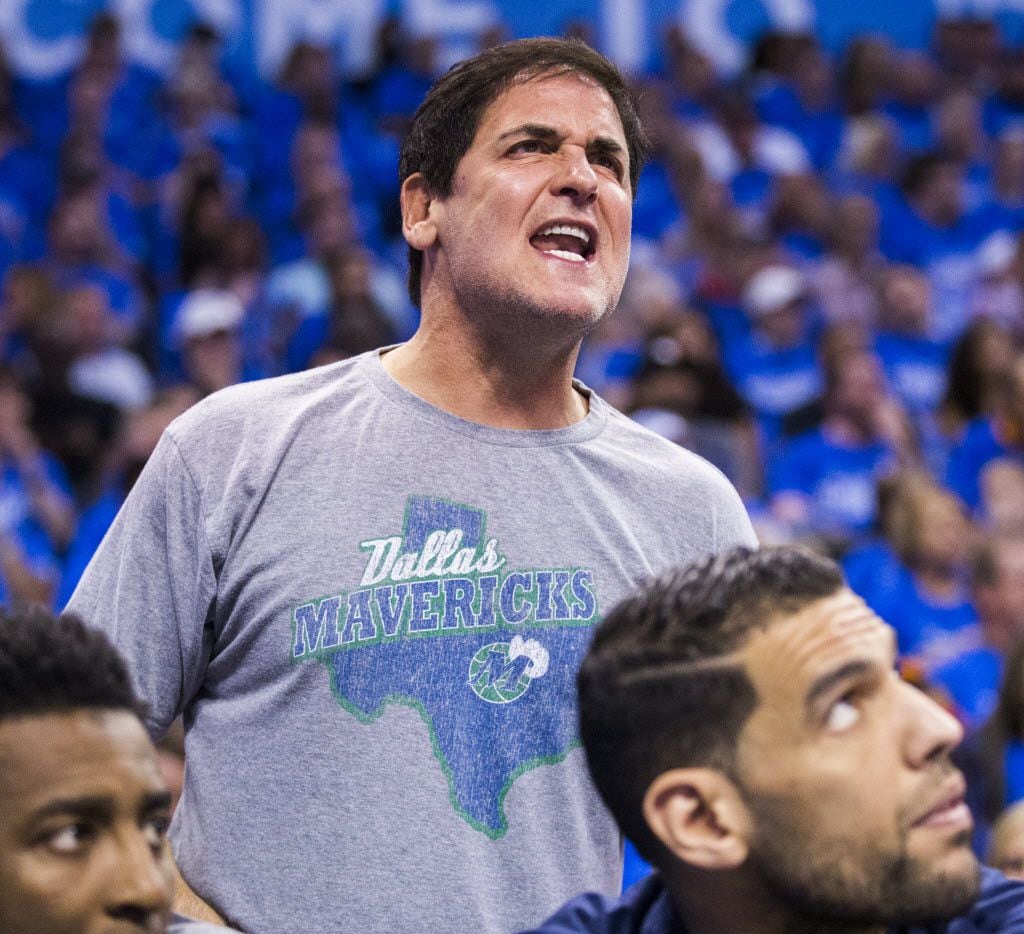 Dallas Mavericks owner Mark Cuban watches from behind the bench during the first quarter of...
