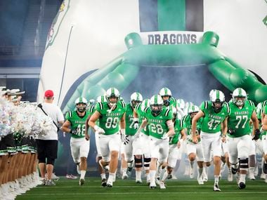 Southlake Carroll players take the field to face Highland Park in a high school football game at AT&T Stadium on Thursday, Aug. 26, 2021, in Arlington.