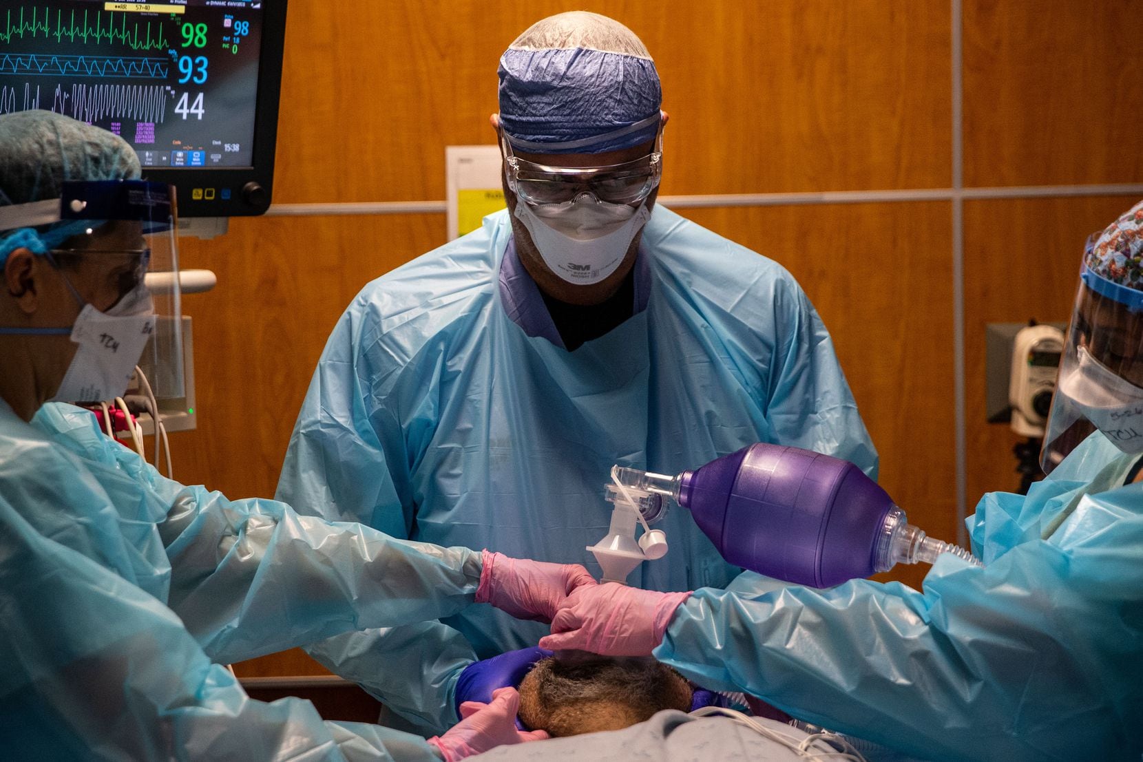 Respiratory therapist Ellen Tabor (right) and certified registered nurse anesthetists Brooke Andrews (left) and Robb Ivy prepare to intubate a COVID-19 patient. The decision to put a patient on a ventilator involves weighing a number of risks, but in the case of this man, his heart was becoming dangerously stressed by his breathing difficulties.
