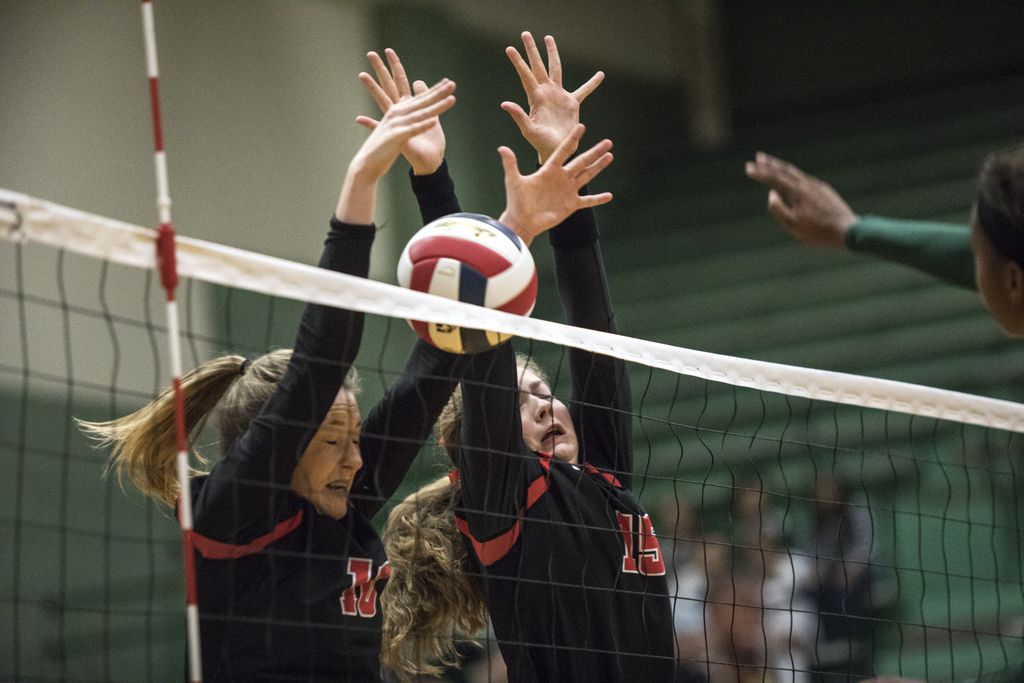 Lovejoy outside hitter Madison Waters (10) and middle blocker Rachel Langs (15) block a...