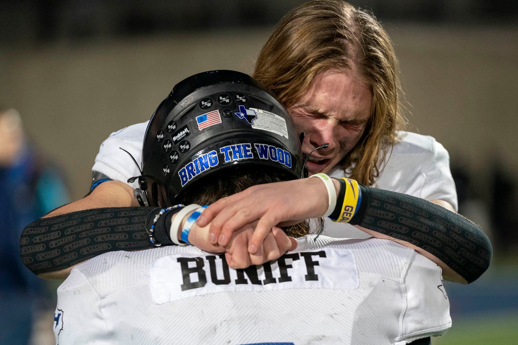 Hebron tight end Carter Brock (12) consoles quarterback Jacob Buniff after their 59-30 loss...