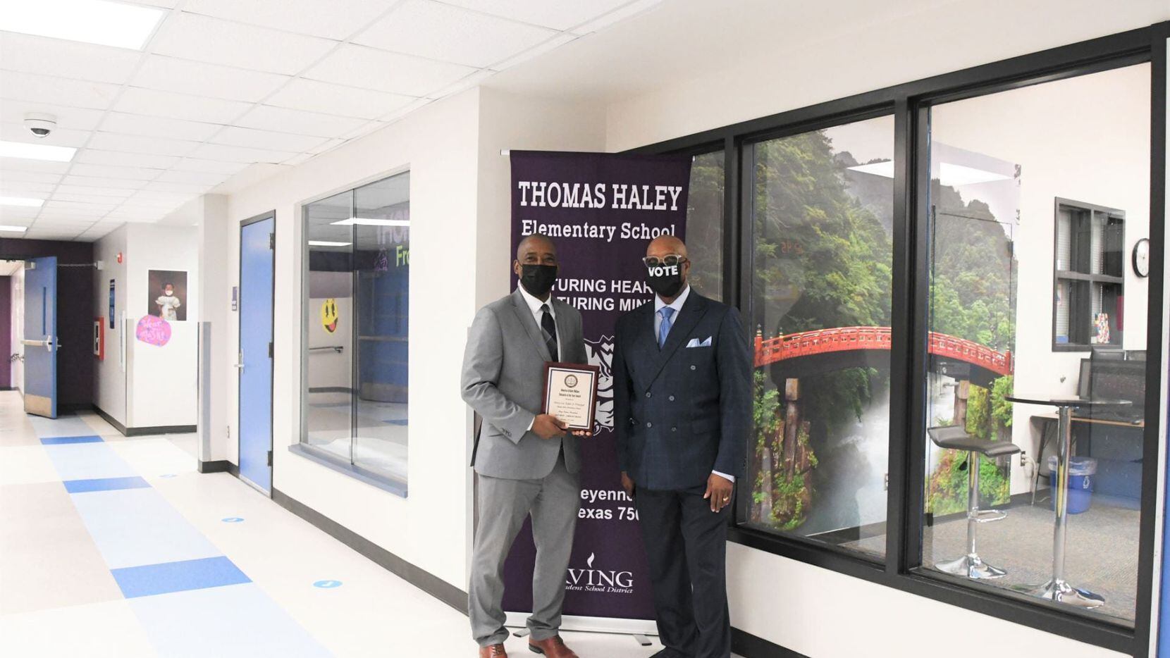 Principal Henry Taylor (left) is pictured with Tony Grimes, NAACP Irving-Carrollton chapter...