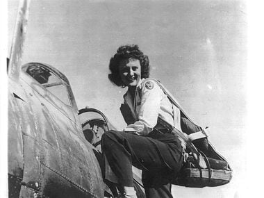 Muriel "Mimi" Lindstrom Segall climbs into a plane during her service a Women Airforce...