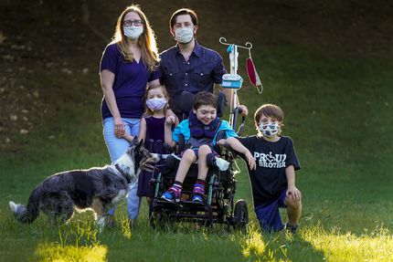 Catherine and Jeff Carlton, shown in their yard with their children (from left) Jenna,...
