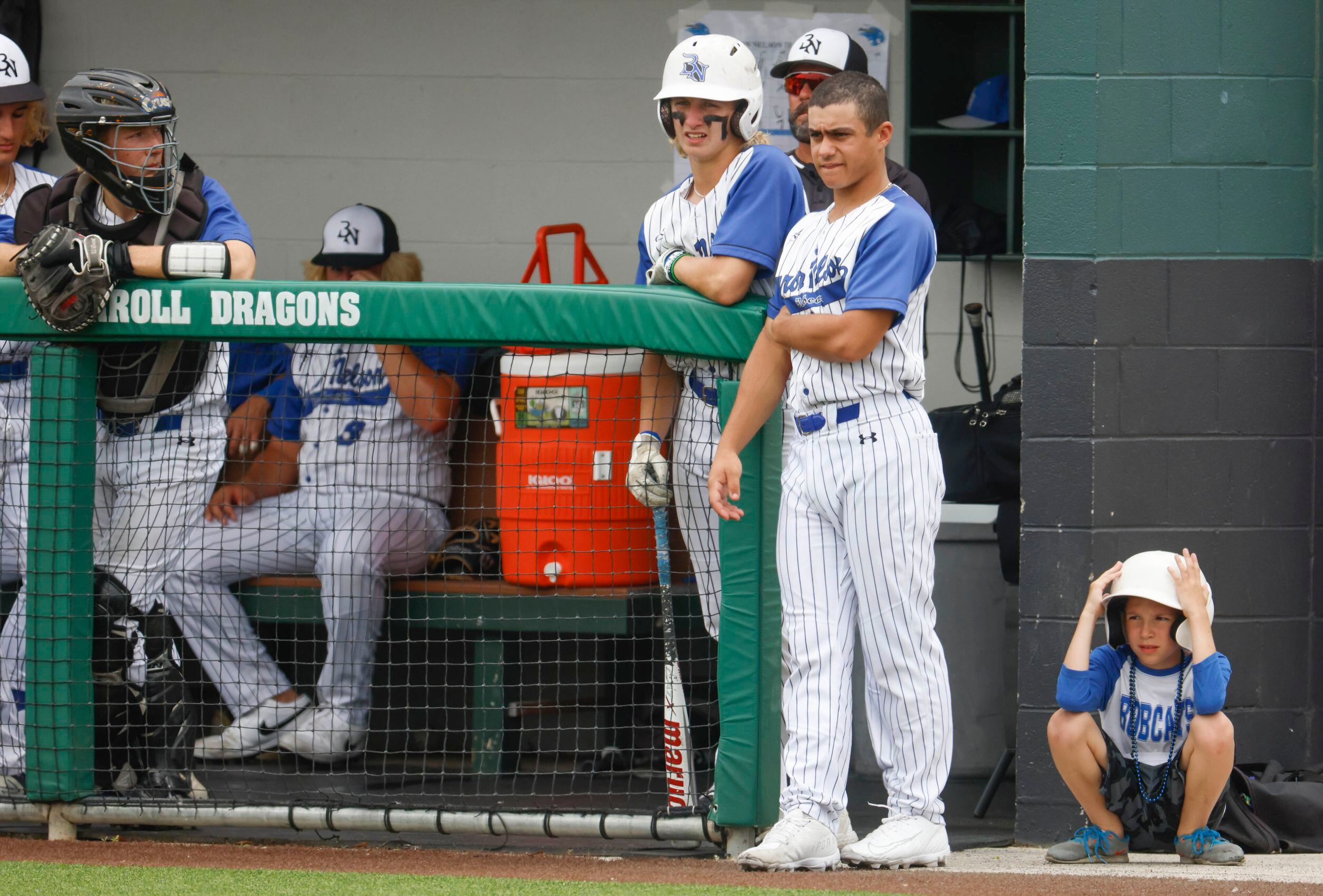 Byron Nelson players remains in the dugout during a baseball game against Denton Guyer on...