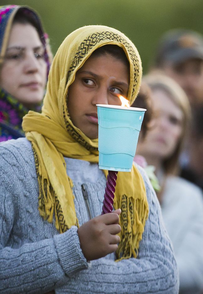 Fajor Ahmed of Sachse holds a candle during the "Remember His Name: Vigil for Jordan...