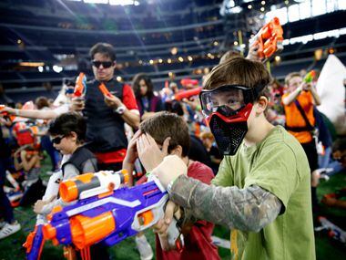 Jered Liske, 10, fires a Nerf gun during Jared's Epic Nerf Battle 2 at AT&T Stadium in...