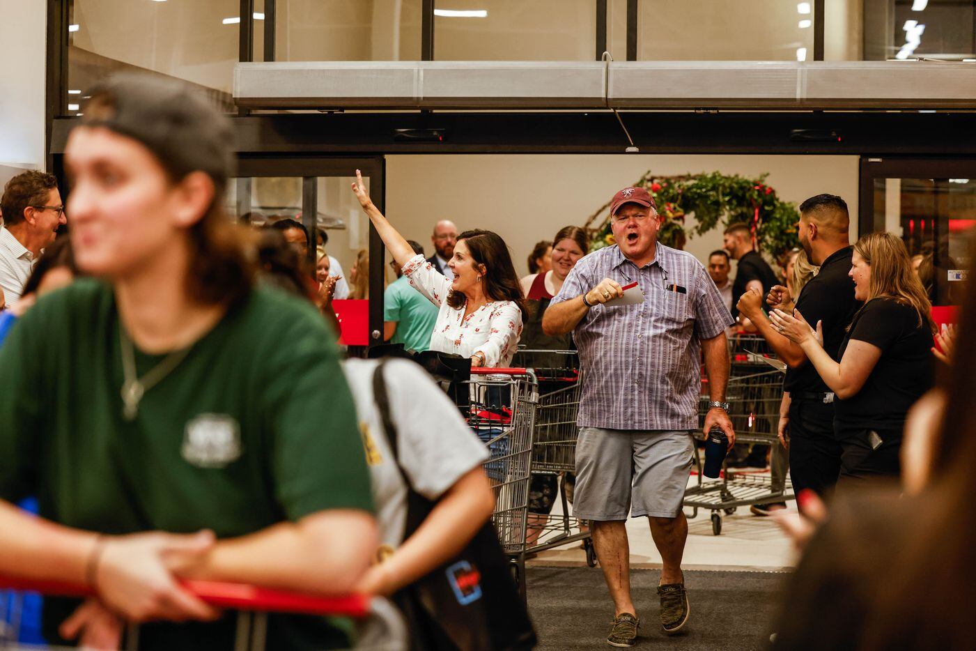 People celebrate as they enter to the new H-E-B store in Frisco on Wednesday, Sept. 21, 2022.