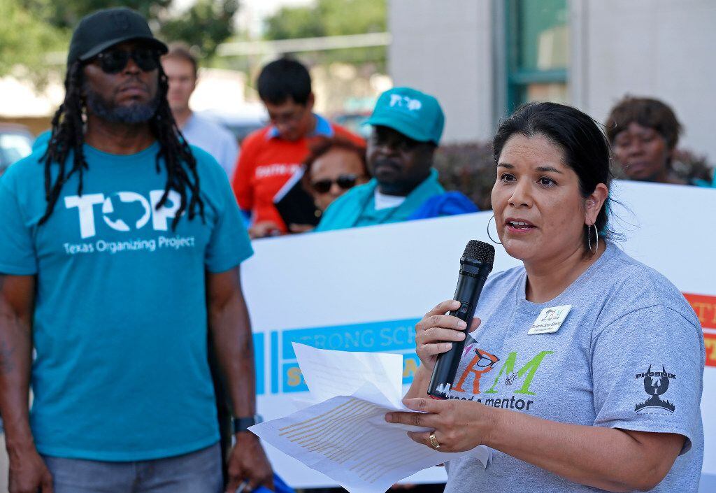 Dolores Sosa Green (right), CEO of Trinity River Mission, reads a statement during a rally...