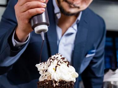 Julian Rodarte, CEO of Trinity Groves and Co-Owner of Nitro Burger, drizzles chocolate sauce...