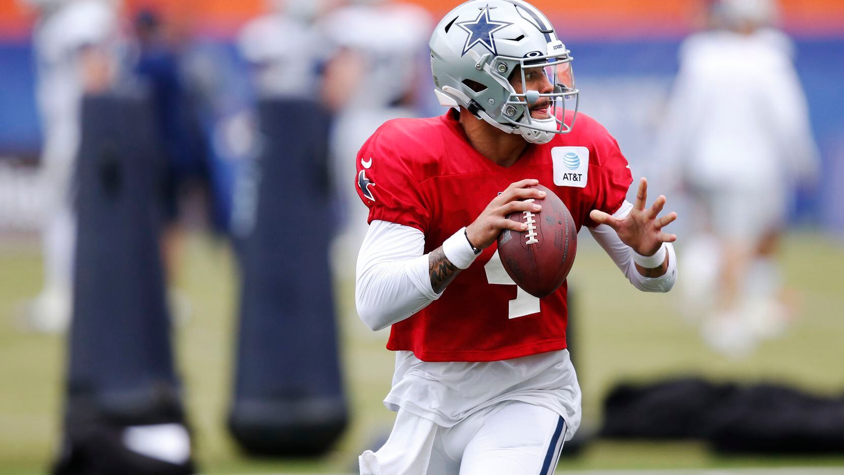 Dallas Cowboys quarterback Dak Prescott (4) runs through a drill in practice during training...