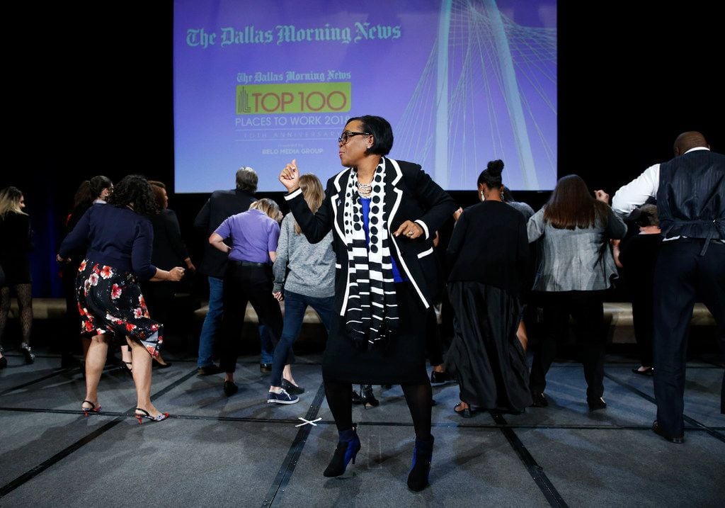 Dallas Mavericks CEO Cynthia Marshall dances with people from the luncheon during her presentation at the Top 100 luncheon at the Omni hotel in Dallas on Thursday, November 1, 2018.