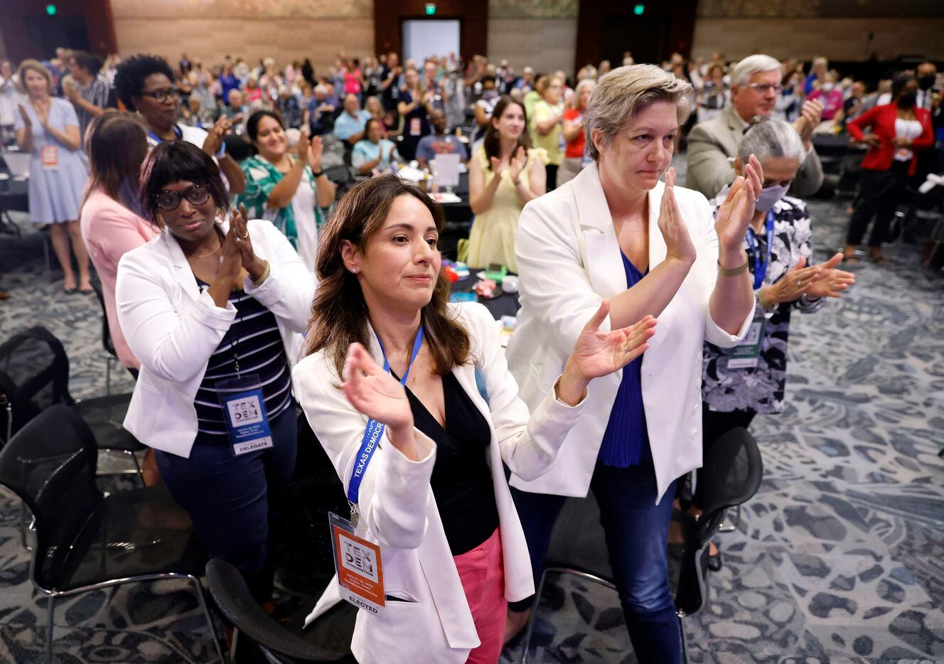 State Representative of Texas Gina Hinojosa (center) and guest Elizabeth Myers (right) stand...