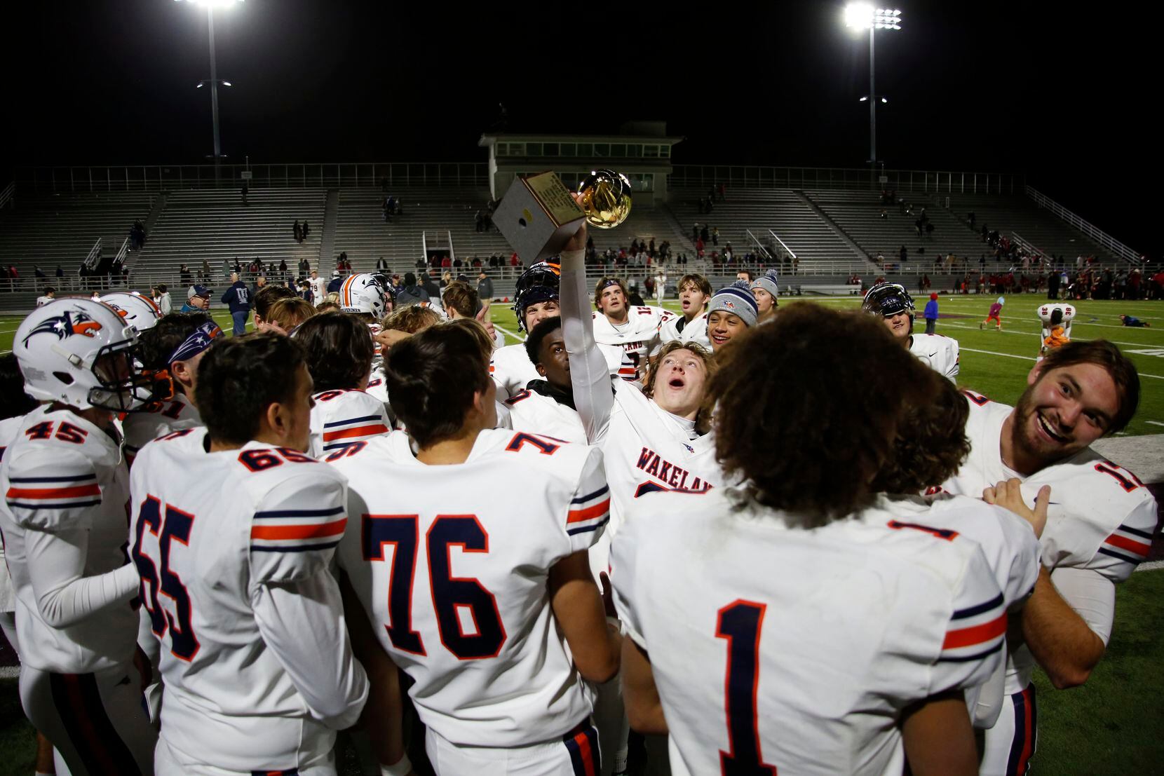 Frisco Wakeland running back Colby Perkes (21) hoists the Class 5A, Division 1 Championship...