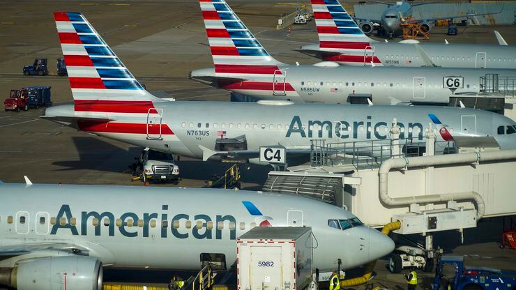 American Airlines planes are seen at the gates of Terminal C at DFW Airport on Monday, March...
