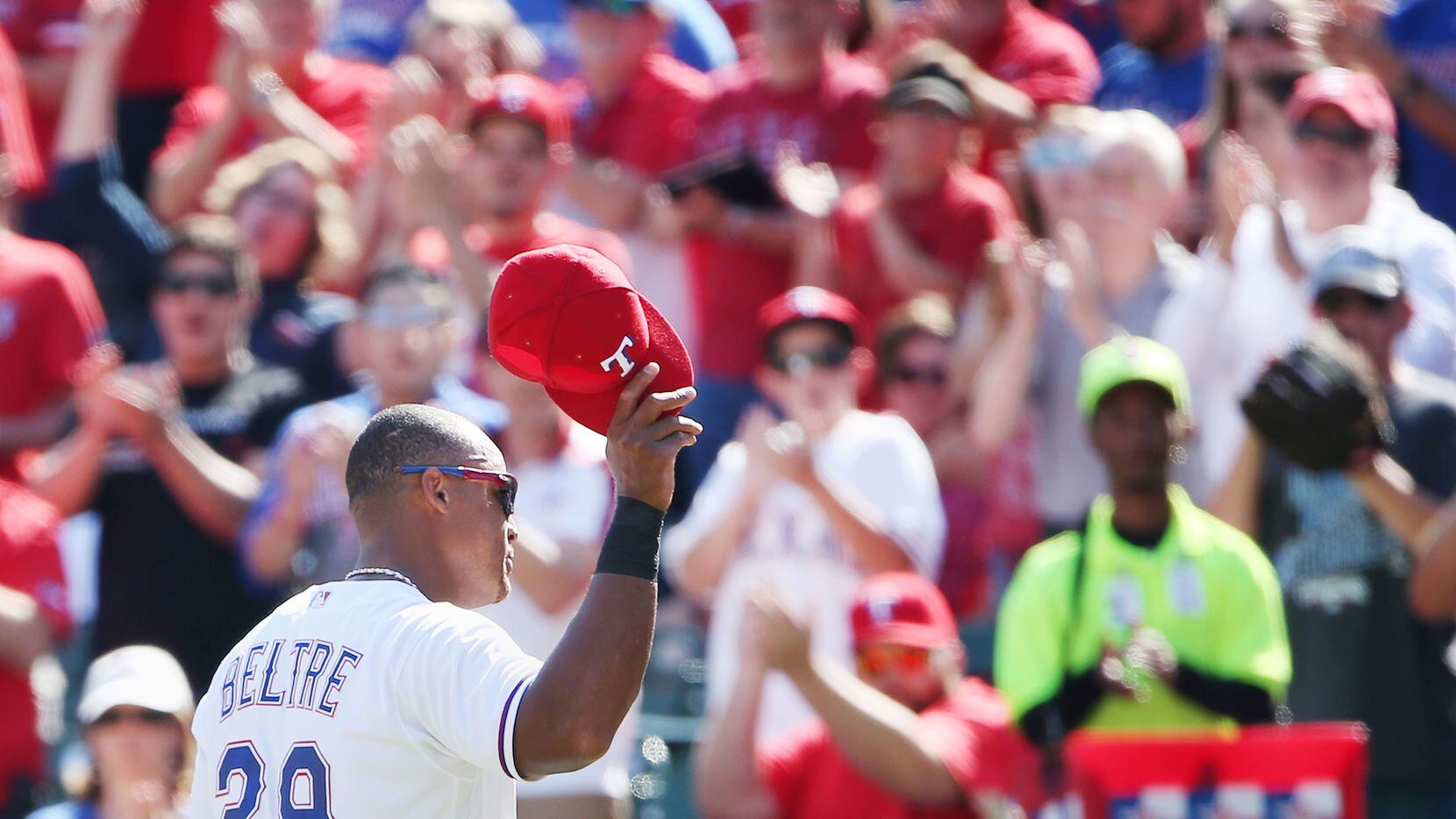 Texas Rangers third baseman Adrian Beltre (29) lifts his hat to the crowd as he leaves the...