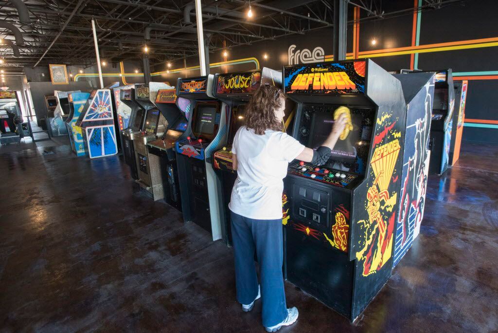 Gayle Wood cleans video games at  Free Play, a retro arcade in Richardson on Friday, Dec. 4,...