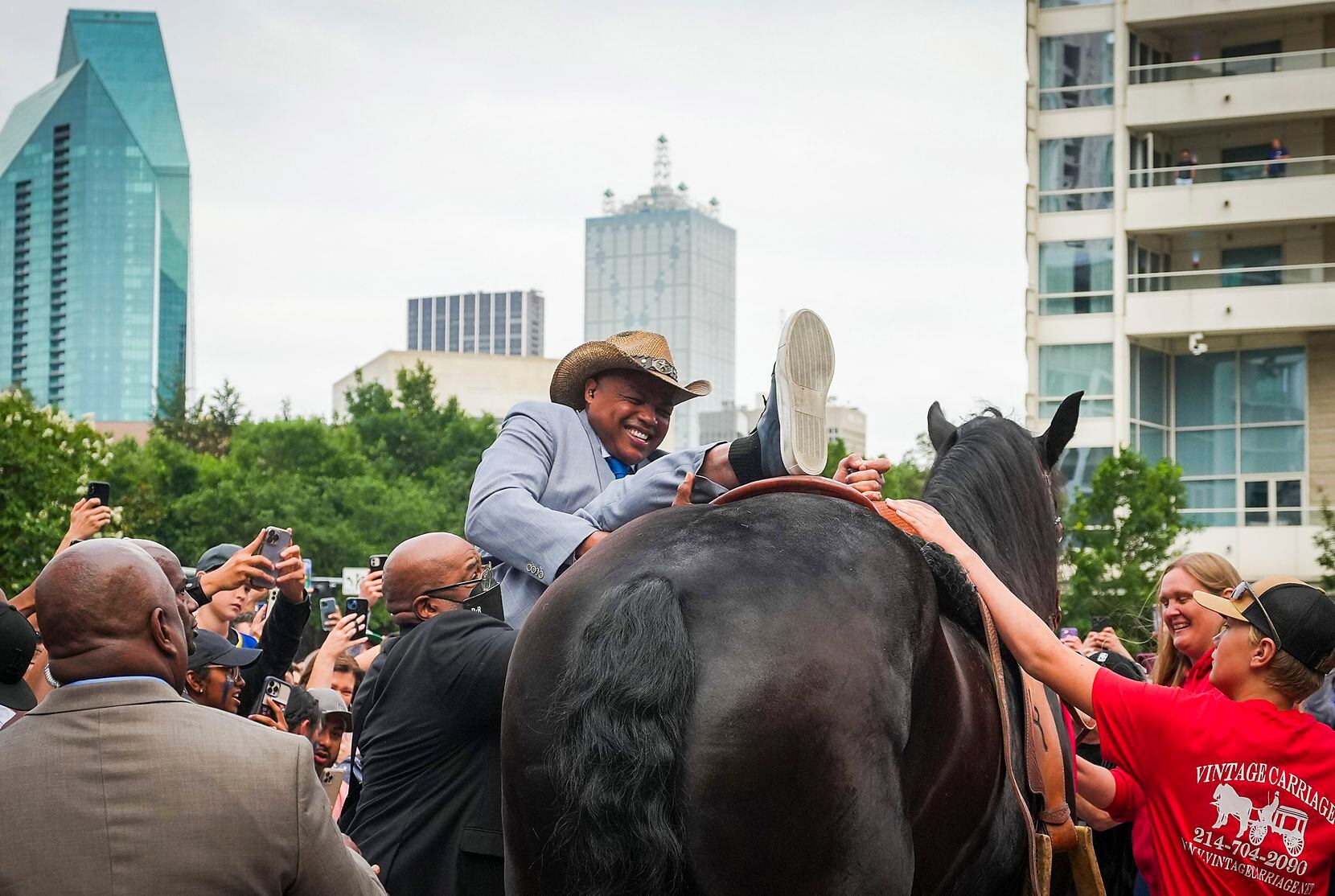 Charles Barkley dismounts a horse as arrives on horseback at the American Airlines Center as...
