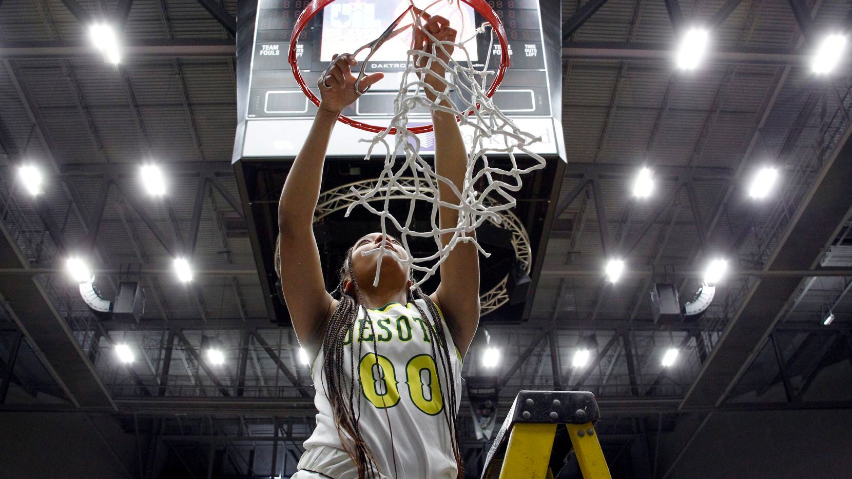 DeSoto guard Mylasia Smith (00) cuts a loop to free the net from the rim following the...
