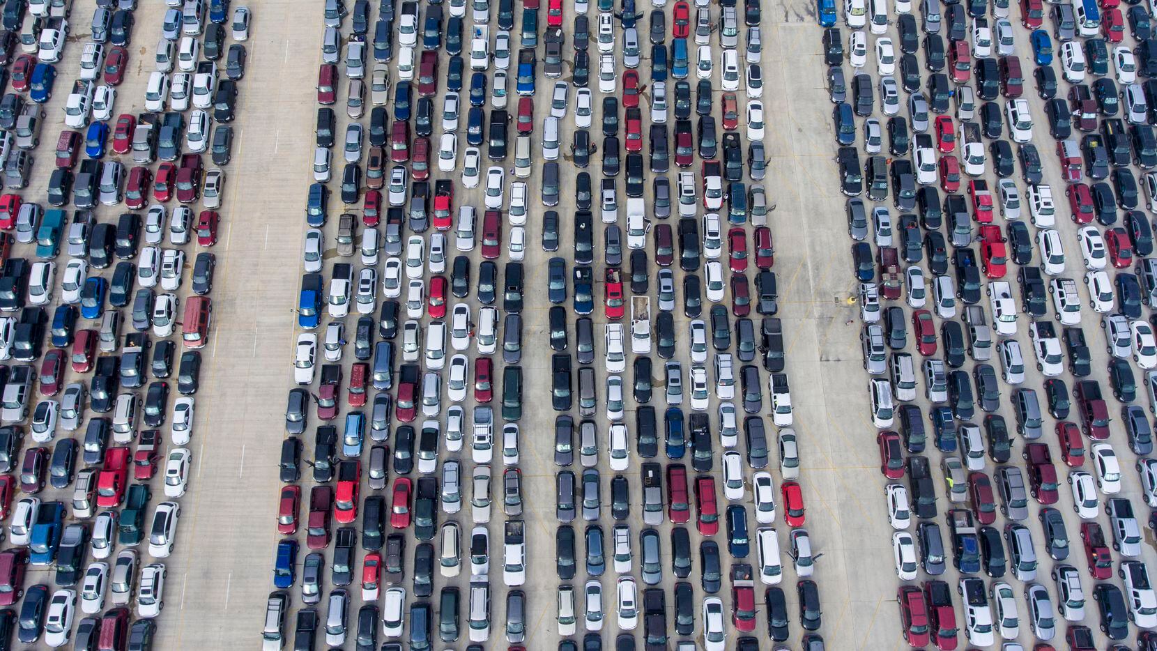 People wait in their cars on Thursday April 9, 2020, at Traders Village for the San Antonio...