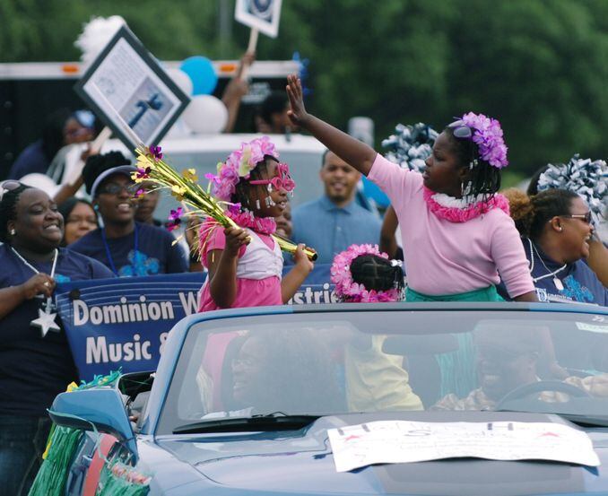 Denton Juneteenth Essay Contest winners wave from a convertible during the Denton Juneteenth...